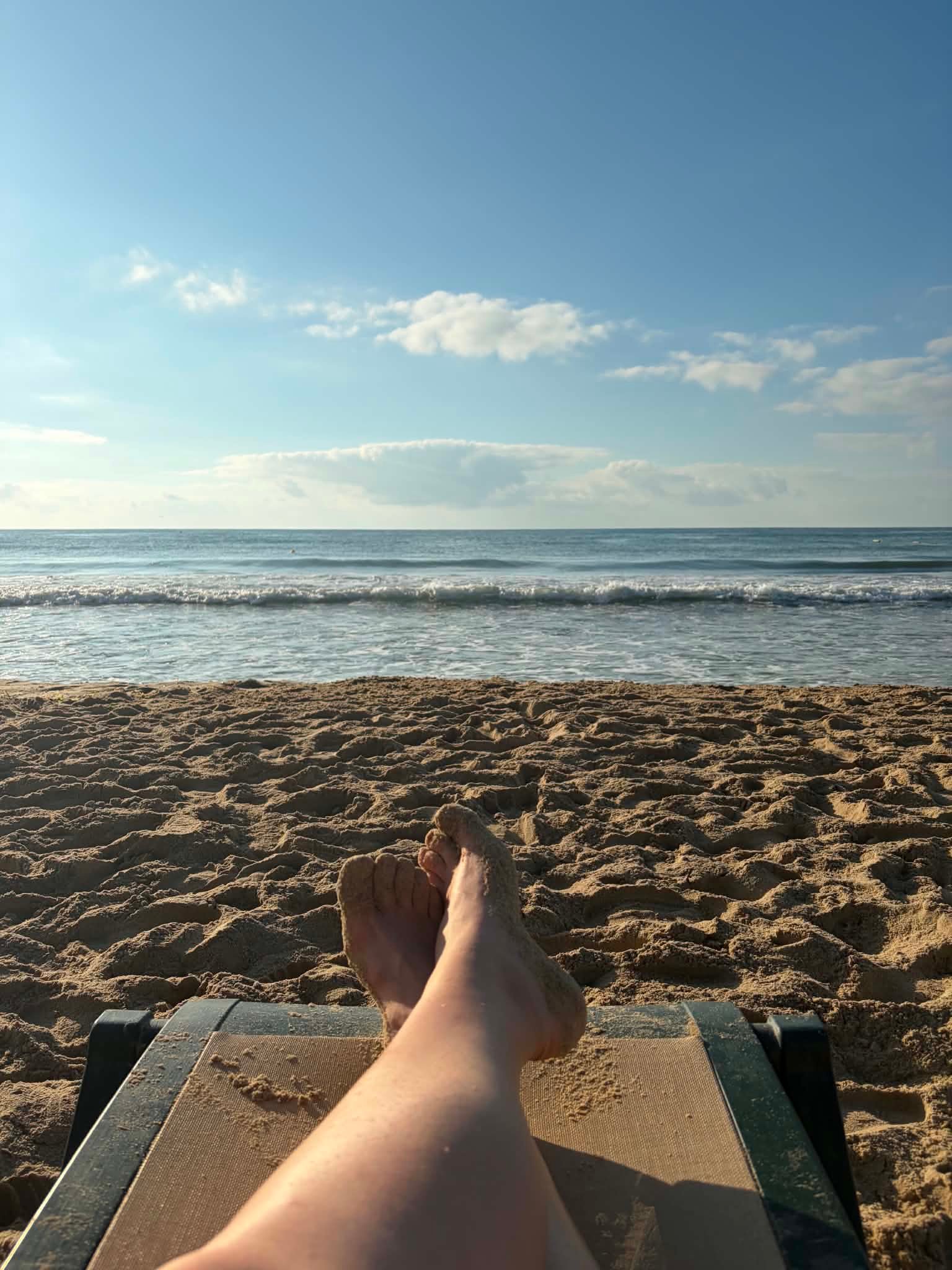 Relaxing on a sunbed with a view of the sea at DIT Evrika Beach Club