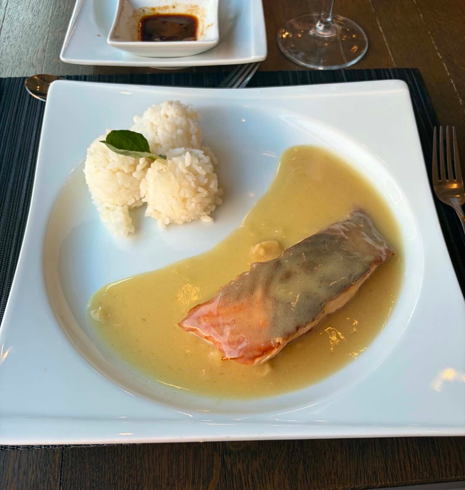A close-up photograph of a beautifully arranged plate of fresh, vibrant salmon in DIT Evrika hotel